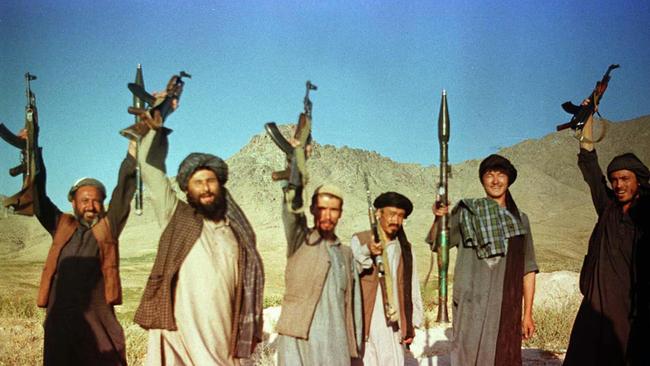 Armed Taliban fighters holding up guns and weapons celebrating at frontline northeast of Kabul 13 Aug 1998. civil war /Afghanistan