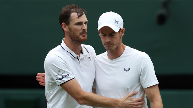 Jamie Murray and Andy Murray of Great Britain embrace following defeat against Rinky Hijikata and John Peers of Australia in the Gentlemen Doubles first round match during day four of The Championships Wimbledon 2024. Picture: Clive Brunskill/Getty Images