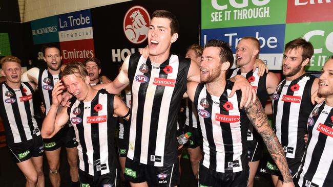Mason Cox celebrates Collingwood’s win over Essendon with his teammates. AAP Image/Julian Smith.