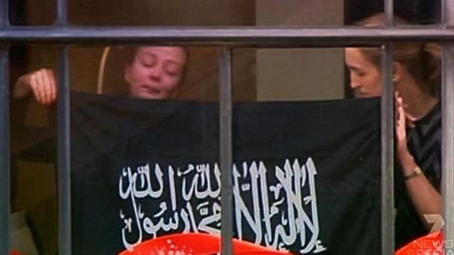 Marcia Mikhael is pictured in the window of the Lindt Cafe during the siege with Katrina Dawson (right).