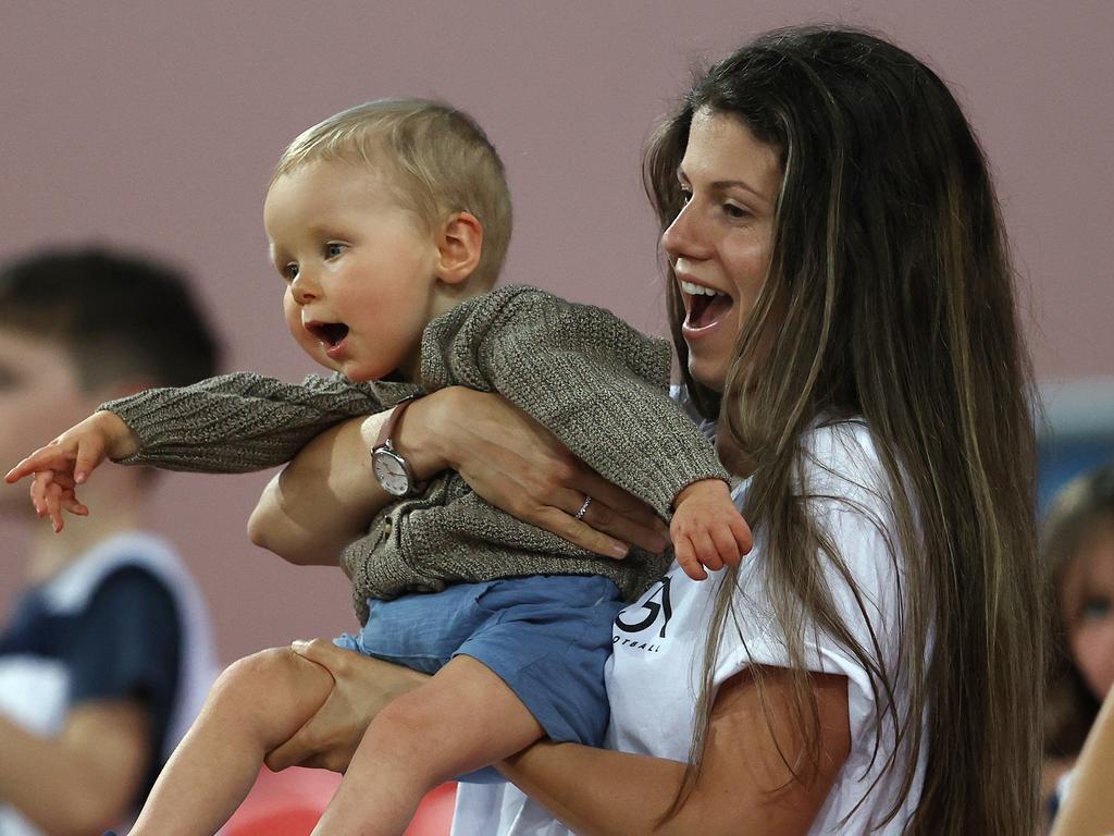 Jordan Ablett and son Levi cheer on dad Gary as the final siren sounds.