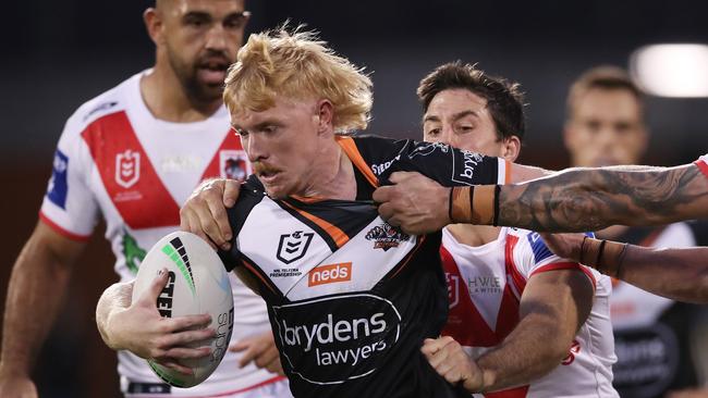 WOLLONGONG, AUSTRALIA - MAY 02:  Zac Cini of the Tigers is tackled during the round eight NRL match between the St George Illawarra Dragons and the Wests Tigers at WIN Stadium, on May 02, 2021, in Wollongong, Australia. (Photo by Matt King/Getty Images)