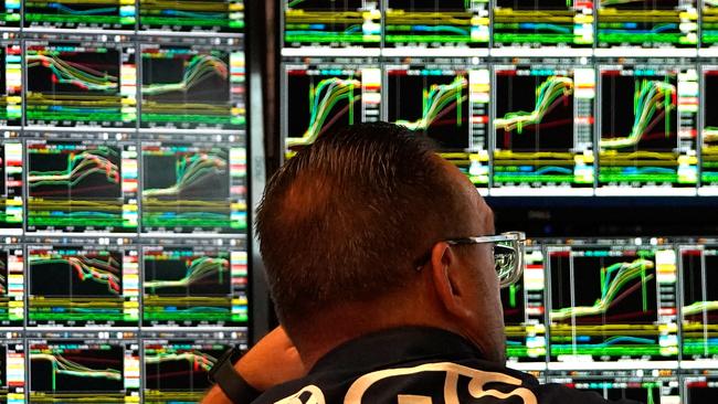 Traders work on the floor of the New York Stock Exchange (NYSE) at the opening bell on November 6, 2024, in New York City. Wall Street stocks surged in opening trading on Wall Street Wednesday after US voters sent Donald Trump back to the White House and delivered him a Republican Senate. Major indices were up 1.8 percent or more in the early going as hopes about expected tax cuts and regulatory easing more than offset worries about higher tariffs. (Photo by TIMOTHY A. CLARY / AFP)