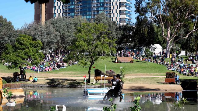 Katlyn Fletcher on Pumpkin rides through the water at Rymill Park as thousands cheer. Picture: NCA NewsWire / Kelly Barnes