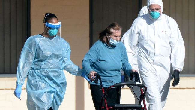 One of the home’s last residents makes her way to an ambulance. Picture: Andrew Henshaw