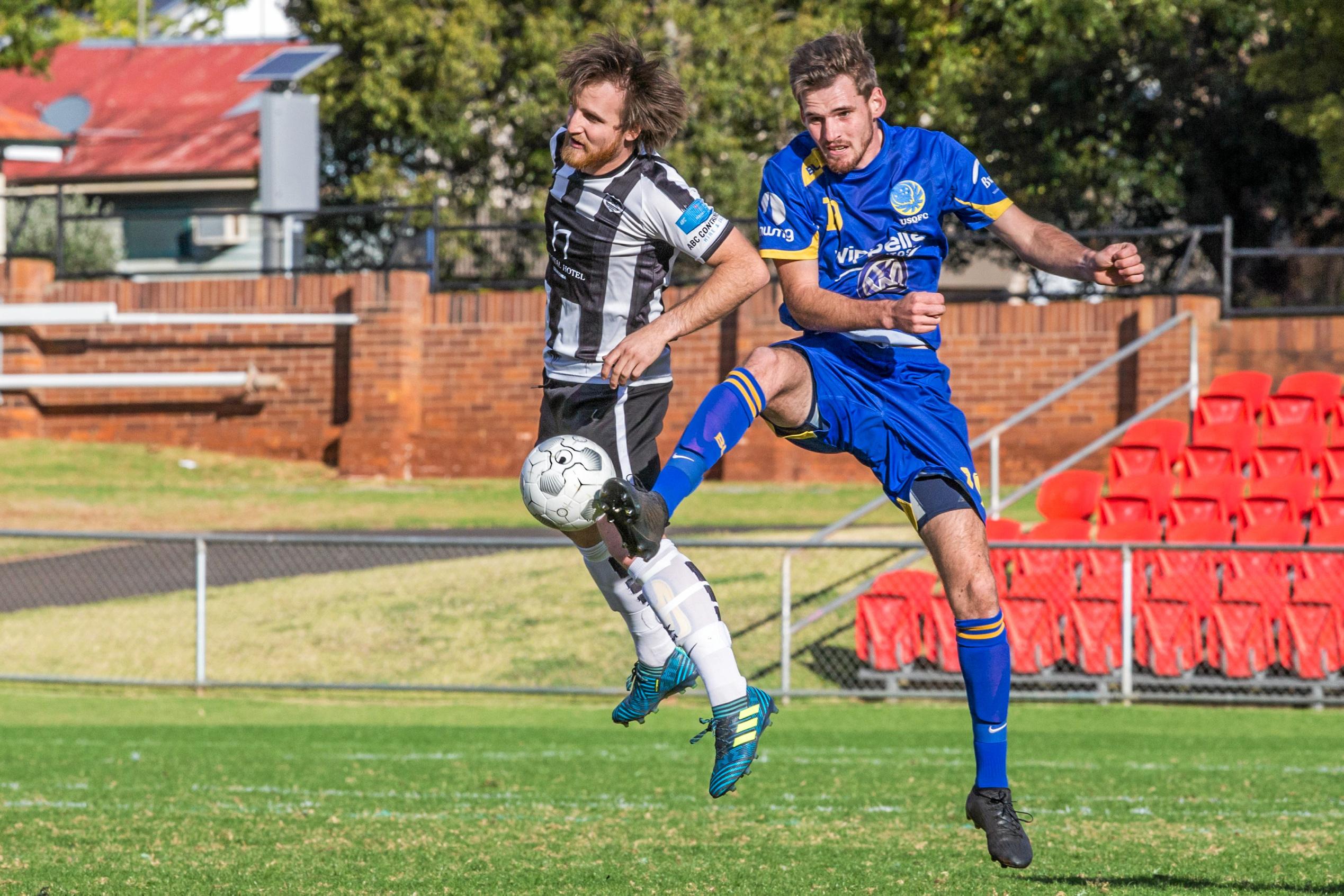 Willowburn's Zach Taylor (left) competes for the ball with USQ FC's Timothy Neels. Picture: Paul Smith