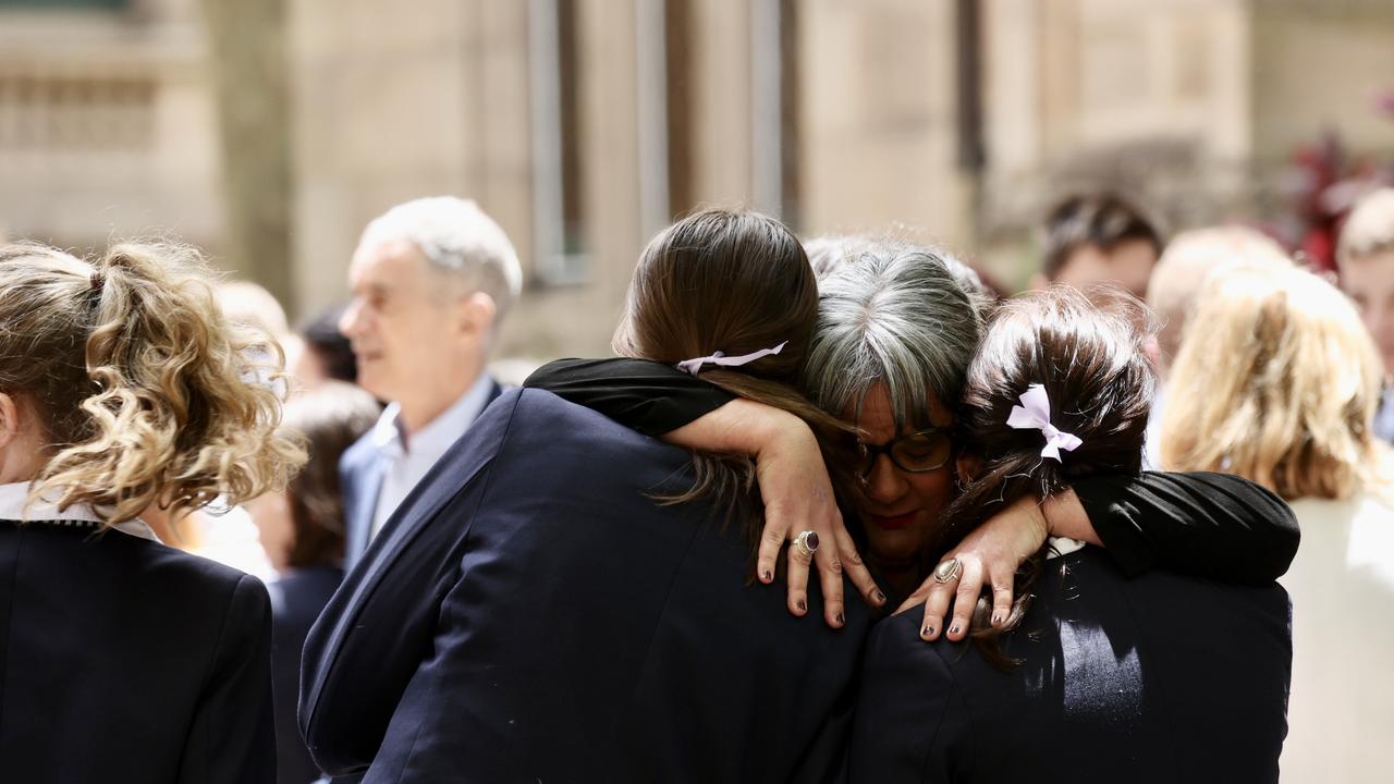 A woman hugs two students outside the service. Picture: NCA NewsWire/ Dylan Robinson