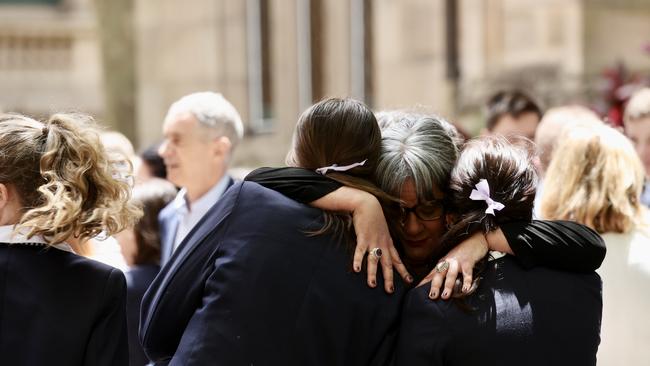 A woman hugs two students outside the service. Picture: NCA NewsWire/ Dylan Robinson