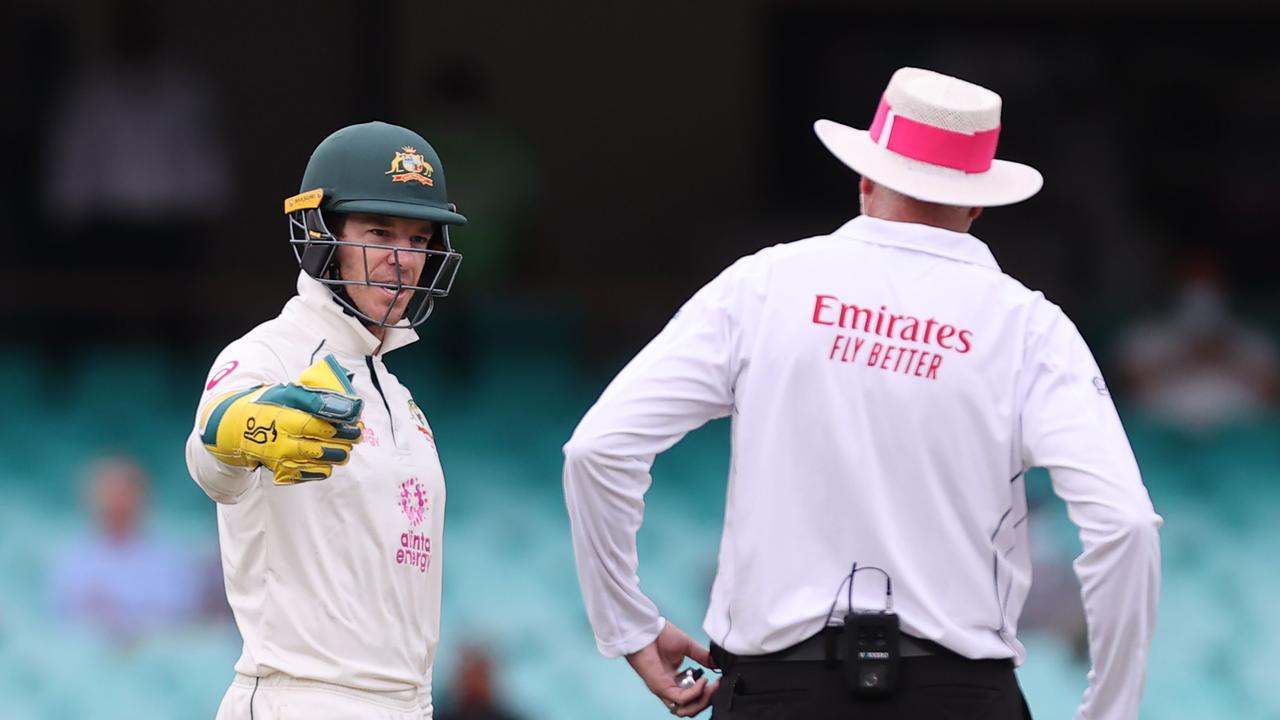 Australia's captain Tim Paine (L) speaks with the umpire