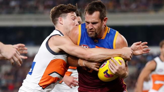 Luke Hodge looks to break through a Toby Greene tackle. Picture: Michael Willson/AFL Photos