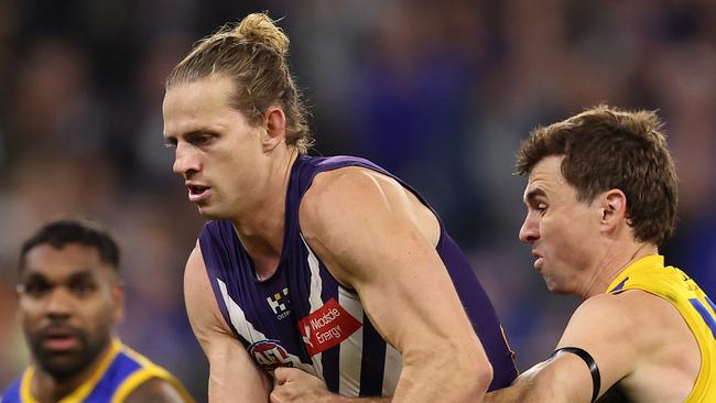 PERTH, AUSTRALIA - JULY 27: Nat Fyfe of the Dockers looks to handball during the round 20 AFL match between Fremantle Dockers and West Coast Eagles at Optus Stadium, on July 27, 2024, in Perth, Australia. (Photo by Paul Kane/Getty Images)