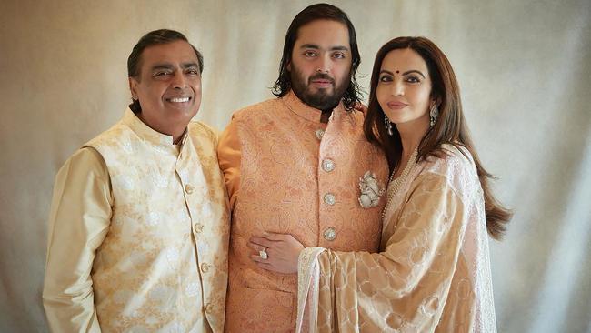 Billionaire tycoon Mukesh Ambani (L) and his wife Nita Ambani (R), chairperson and founder of the Reliance Foundation with their son Anant Amban. Picture: Photo by Reliance / AFP