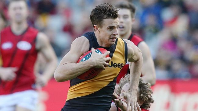 Brett Deledio shrugs off a would-be Essendon tackler. Picture: Wayne Ludbey