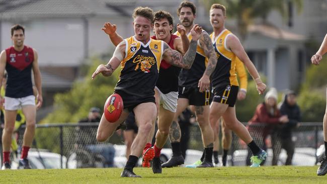 MPNFL: Frankston YCW’s Thomas Baker gets a kick away. Picture: Valeriu Campan