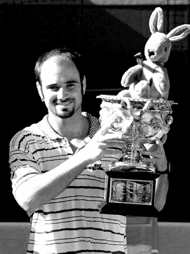 Andre Agassi holds trophy after defeating Pete Sampras in final of Ford Australian Open Championship in Melbourne 1995.