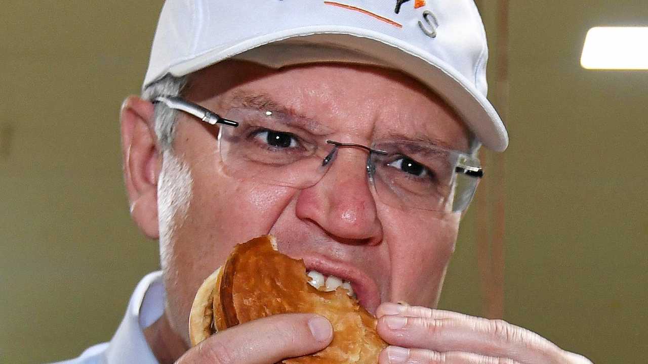 Australian Prime Minister Scott Morrison eats a pie during a visit to the Beefy's Pies factory near Maroochydore on the Sunshine Coast, Tuesday, November 6, 2018. Mr Morrison is on a four-day bus tour of Queensland. (AAP Image/Dan Peled) NO ARCHIVING