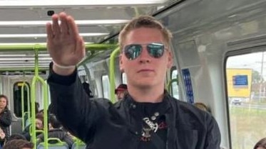 A known neo-Nazi has been captured performing the near-banned salute on-board a busy Melbourne train.