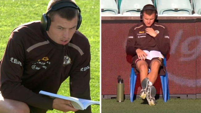 Jack Ginnivan gets some light reading done pre-game.