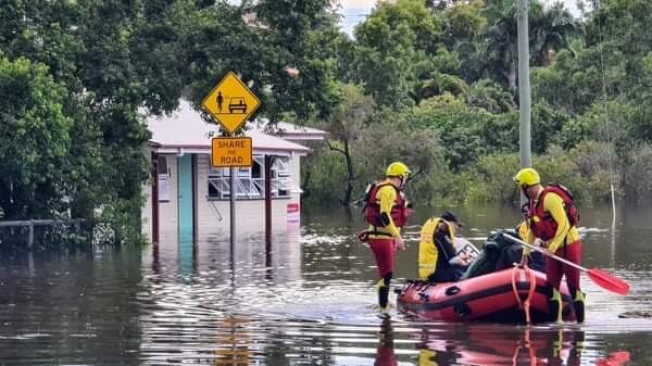 Emergency crews make their way through floodwaters at Tinana, on the Fraser Coast.