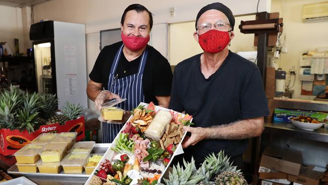 Stratford Deli chef Terry Davis and owner Eugene Grossman have been flat out preparing pre-packed meals and platters, which can also be delivered anywhere in Cairns if given enough notice. Picture: Brendan Radke