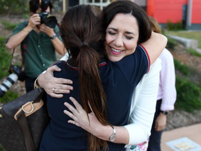 Queensland Premier Annastacia Palaszczuk hugs a nursing staff member outside the Gold Coast University Hospital on the last day of the campaign.