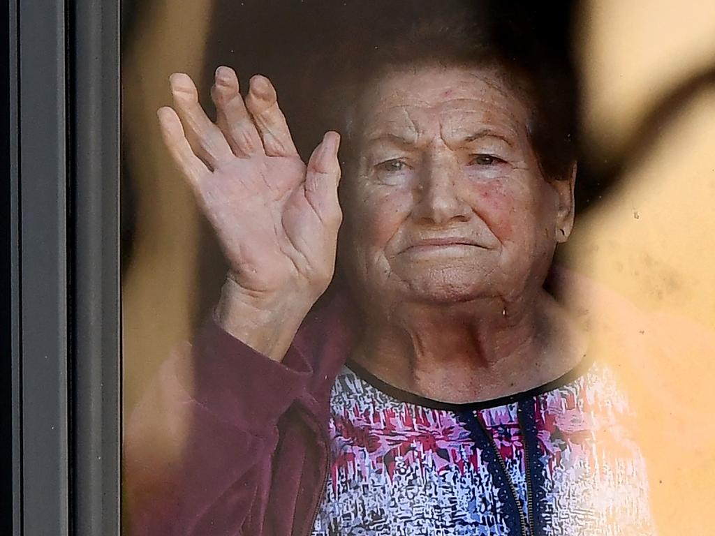 A resident gestures from an aged care facility in the Melbourne suburb of Maidstone on May 31, 2021. Picture: William West/AFP