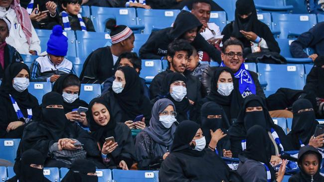 Female supporters of Saudi's Al-Hilal attend their team's football match against Al-Ittihad in the Saudi Pro League at the King Fahd International Stadium in Riyadh on January 13, 2018. Saudi Arabia allowed women to enter a football stadium for the first time to watch a match on January 12, as the ultra-conservative kingdom eases strict decades-old rules separating the sexes. / AFP PHOTO / Ali AL-ARIFI