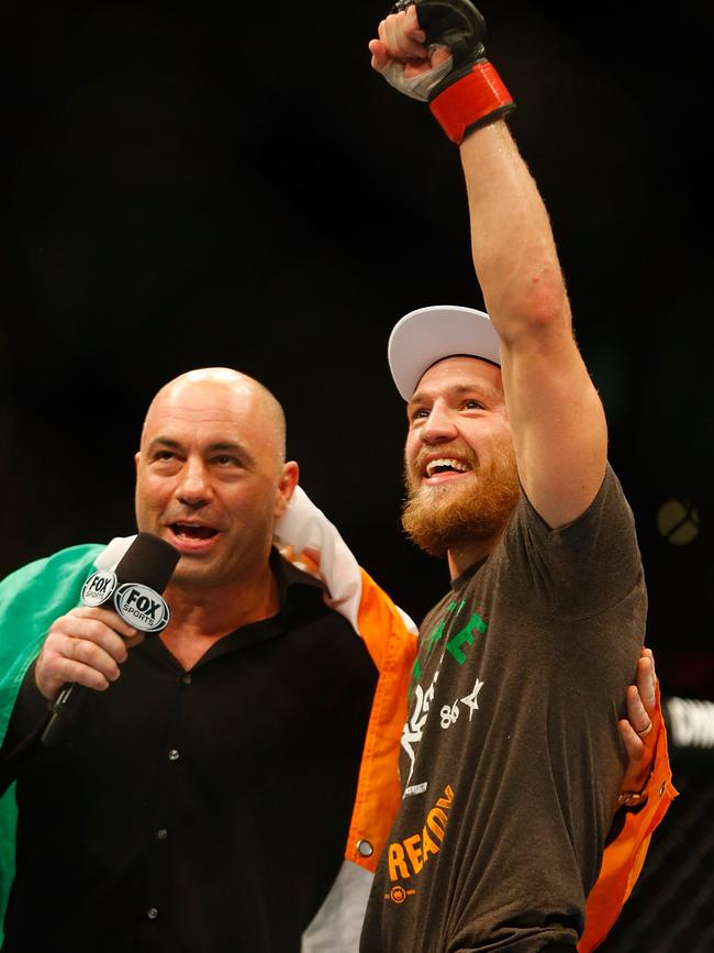 Conor McGregor celebrates next to Joe Rogan following his win against Max Holloway in August 2017. (Photo by Jared Wickerham/Getty Images)