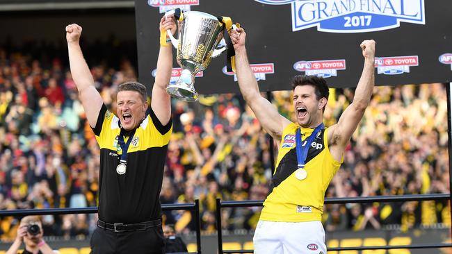 Damien Hardwick and Trent Cotchin lift the premiership cup.