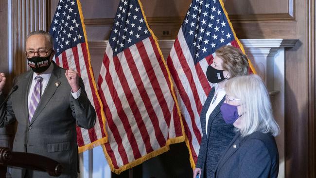 Senate Majority Leader Chuck Schumer talks to reporters in a break in proceedings.