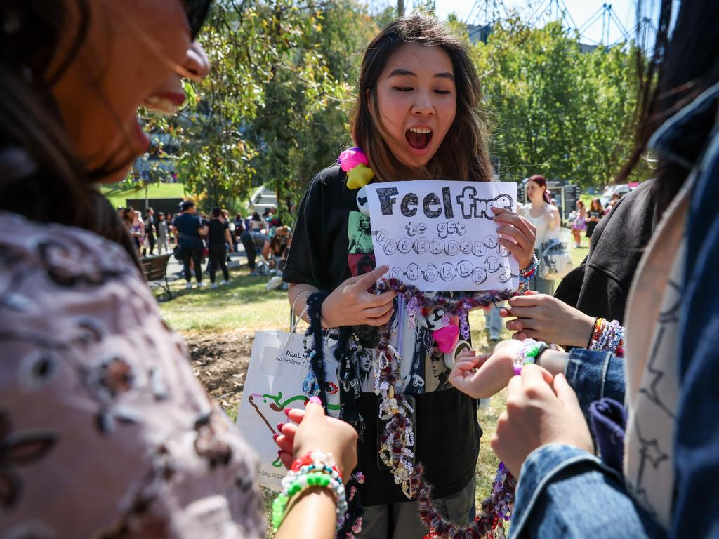 "Swifties" exchange friendship bracelets worn on their wrists as they arrive.