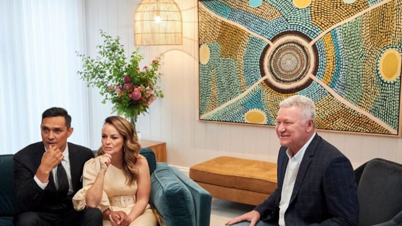 The ‘Gaagal’ artwork behind the couple and host Scott Cam is for sale, with a portion of the proceeds going to the RFS.