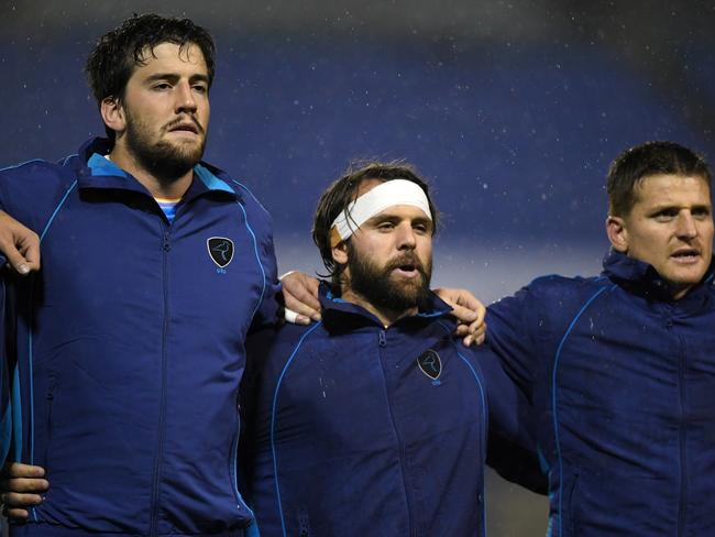 Ignacio Dotti, Federico Favaro and Leandro Leivas of Uruguay sing the national anthem.