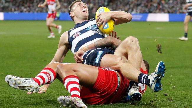 An awkward Buddy Franklin tackle was the second time Joel Selwood hurt his ankle on Friday night. Photo: Getty Images