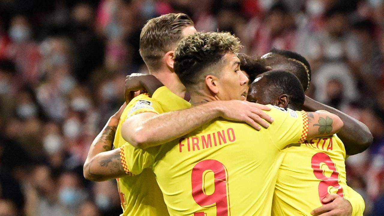 Liverpool's Guinean midfielder Naby Keita (R) celebrates with teammates after scoring a goal during the UEFA Champions League Group B football match between Atletico Madrid and Liverpool at the Wanda Metropolitano stadium in Madrid on October 19, 2021. (Photo by JAVIER SORIANO / AFP)