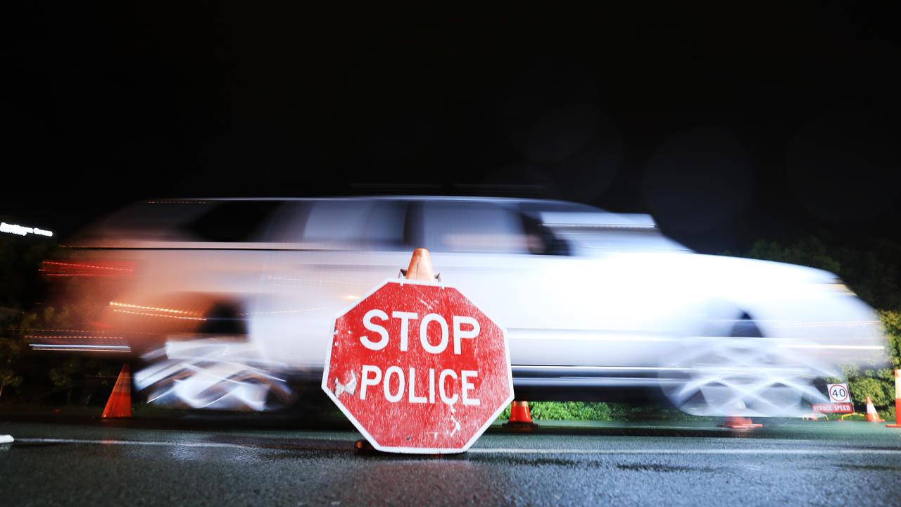 Queensland Police Officers with the assistance of The Australian Army stop all traffic into Queensland for checks at 1am on QLD/NSW border crossing on August 8. Picture: Scott Powick