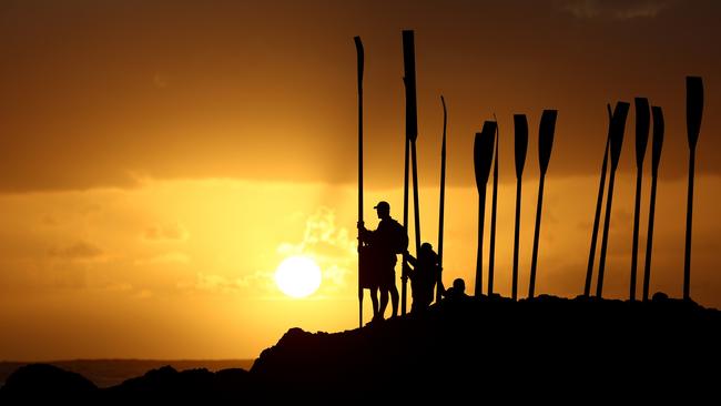 Club members hold oars for a symbolic burial at sea on April 25, 2023 in Currumbin, Australia. Photo by Chris Hyde/Getty Images