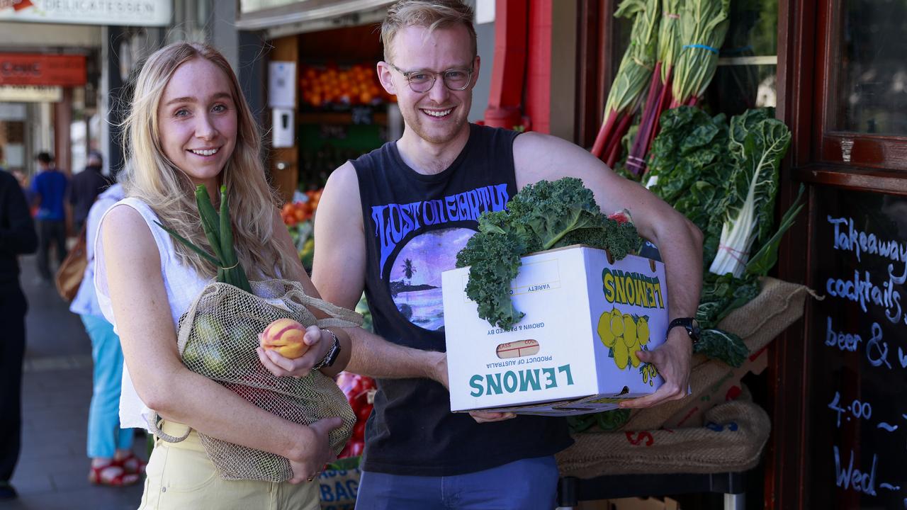 Katie Watts and Murray Taylor get hands-on with the fresh produce at Galluzzo Fruiterers in Glebe. Picture: Justin Lloyd.