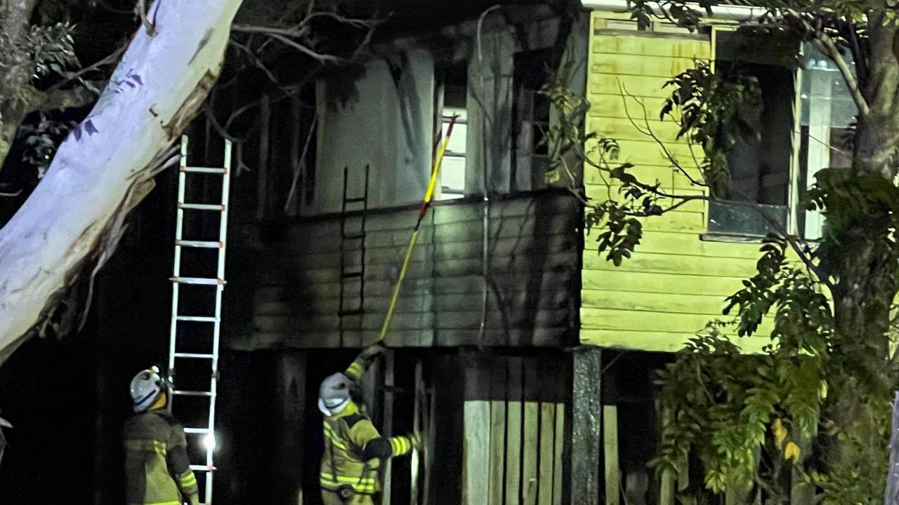 Firefighters get access to the charred home.