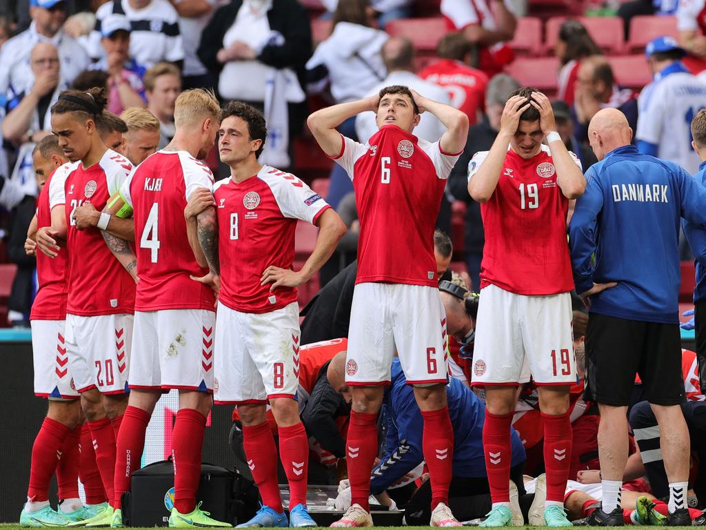 Denmark’s players form a shield as paramedics attend to Denmark's midfielder Christian Eriksen.