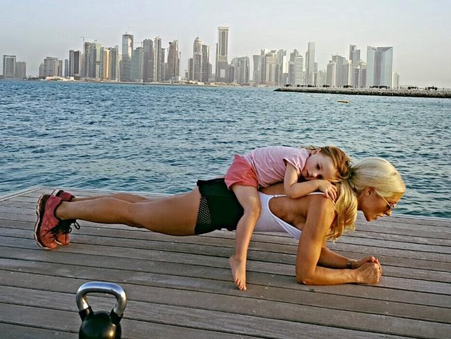 Simone uses the kids as weights. Picture: Caters News