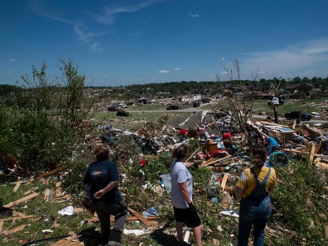 A woman overlooks the remnants of her house in London, Kentucky. Picture: Getty Images via AFP