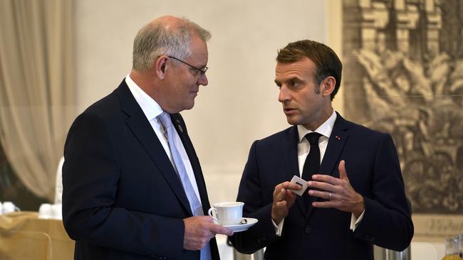 Australian Prime Minister Scott Morrison and French President Emmanuel Macron talk before the G20 leaders make a short visit to the Fontana di Trevi. Picture: Adam Taylor