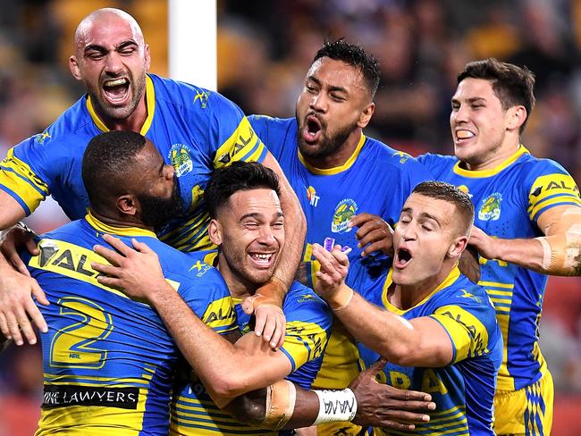 BRISBANE, AUSTRALIA - AUGUST 24:  Semi Radradra of the Eels is congratulated by team mates after scoring a try during the round 25 NRL match between the Brisbane Broncos and the Parramatta Eels at Suncorp Stadium on August 24, 2017 in Brisbane, Australia.  (Photo by Bradley Kanaris/Getty Images) *** BESTPIX ***
