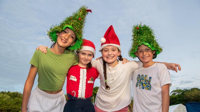 Zoe Moir, Emma Goodwin, Indiana Heffernan and Vincent Nichols got in the Christmas spirit during the annual Carols by Candlelight at the Botanical Gardens on Sunday night which attracted thousands to the Amphitheatre for a warm night of carols. Picture: Pema Tamang Pakhrin.