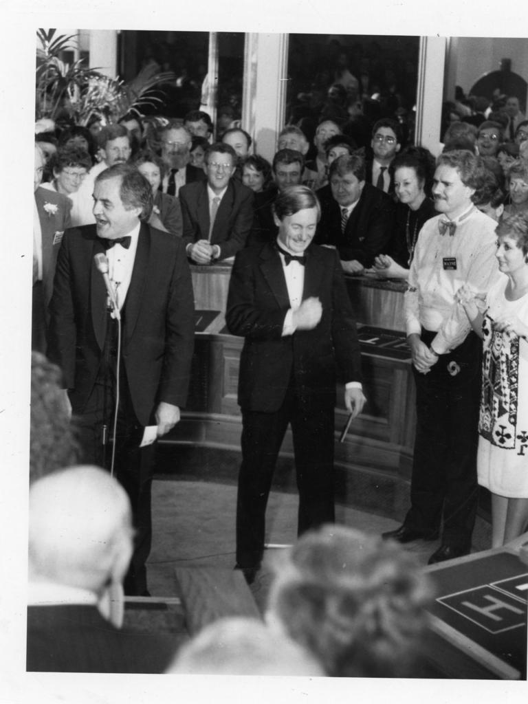 SA Premier John Bannon in the two-up pit comes up tails after tossing coins to open the Adelaide Casino, December, 1985. He is pictured with media personalities Bob Francis and Anne Wills.