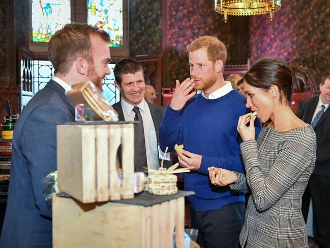 Britain’s Prince Harry and his fiancée Meghan Markle taste traditional Welsh cakes during a visit at Cardiff Castle in Cardiff, south Wales on January 18, 2018, for a day showcasing the rich culture and heritage of Wales. Picture: AFP