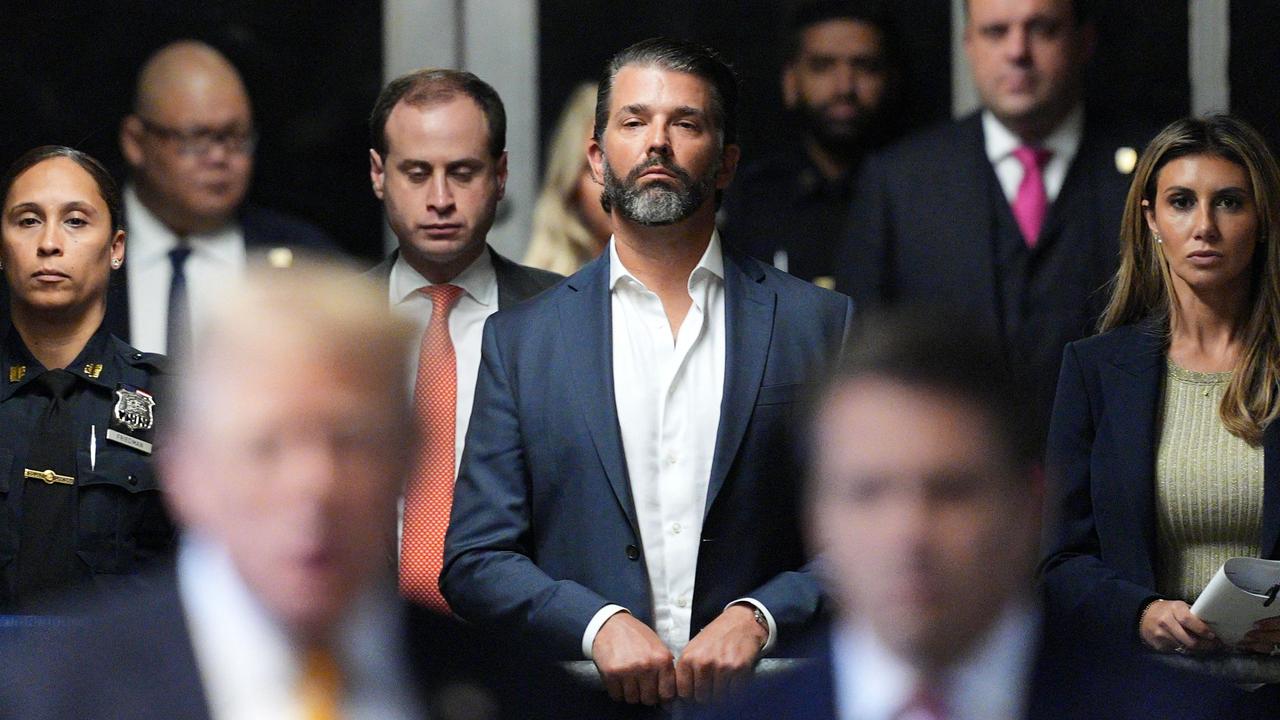 Donald Trump Jr. (C) and lawyer Alina Habba (R) look on. (Photo by Curtis Means / POOL / AFP)