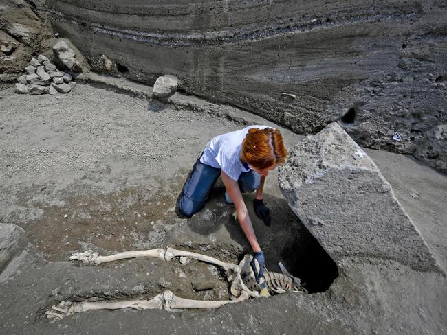 Anthropologist Valeria Amoretti works with a brush on a skeleton of a victim of the eruption of Mt. Vesuvius in A.D. 79, which destroyed the ancient town of Pompeii. Picture: Ciro Fusco/ANSA via AP