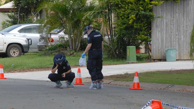 Forensic Police work at the scene at Elm Dr in Andergrove near appears to be a knife is on the road in front of officer on left. Photo: Tony Martin